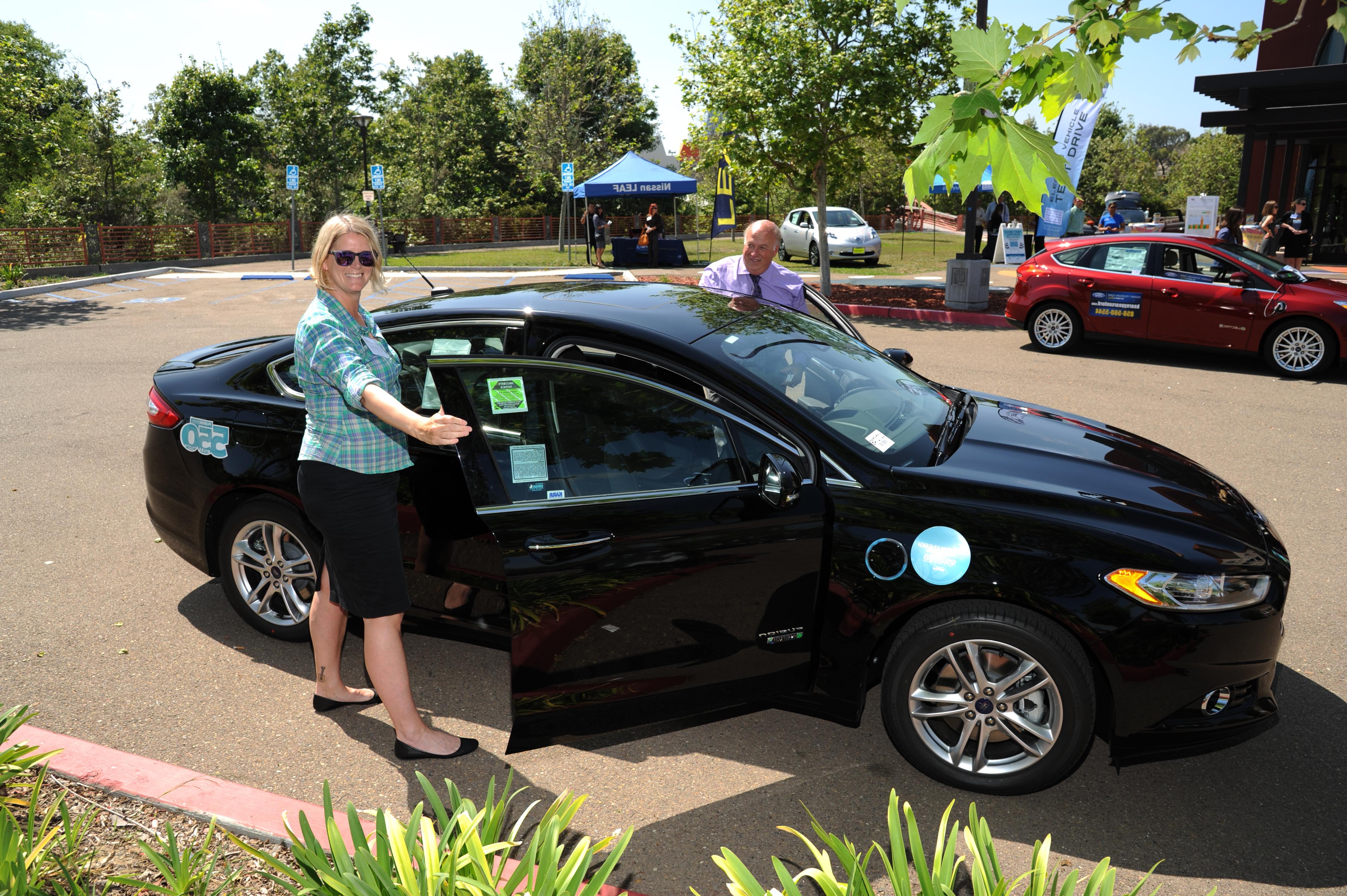 People standing next to a car